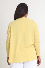 Model Ashleigh wearing size 16 of the My Boyfriends Slouch Cardi in colour Butter, from the back