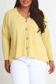 Model Ashleigh wearing size 16 of the My Boyfriends Slouch Cardi in colour Butter, from the front, cropped image