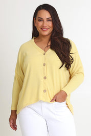 Model Ashleigh wearing size 16 of the My Boyfriends Slouch Cardi in colour Butter, from the front, cropped image