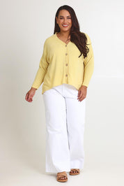 Model Ashleigh wearing size 16 of the My Boyfriends Slouch Cardi in colour Butter, from the front, showing the whole outfit