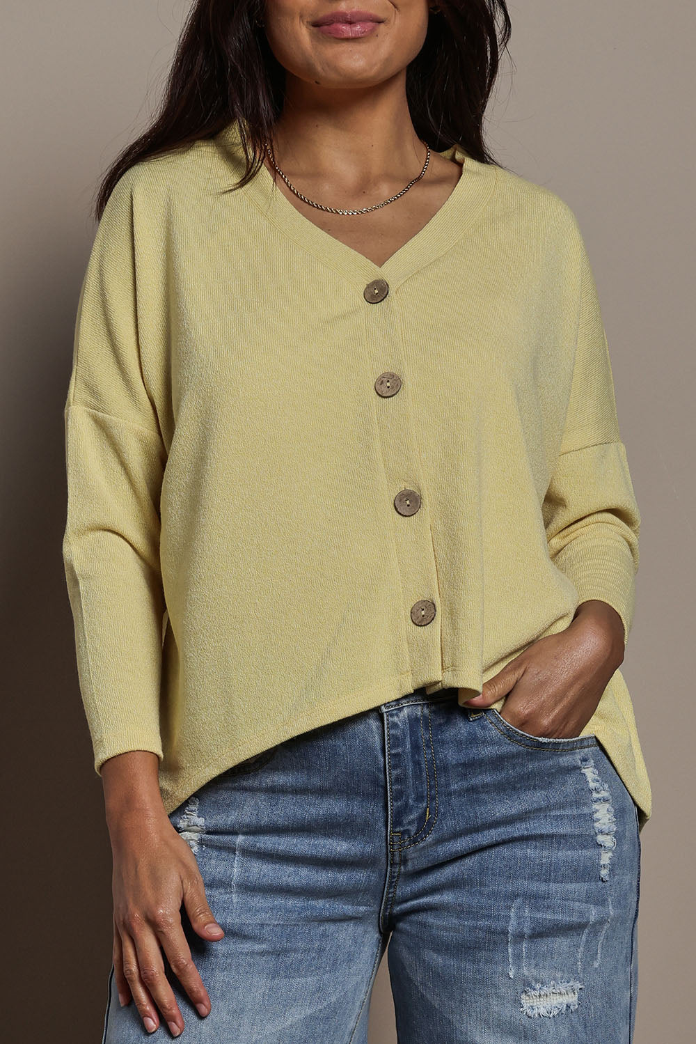 Model Tahnee wearing size 10 of the My Boyfriends Slouch Cardi in colour Butter, from the front, cropped image