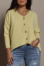 Model Tahnee wearing size 10 of the My Boyfriends Slouch Cardi in colour Butter, from the front, cropped image