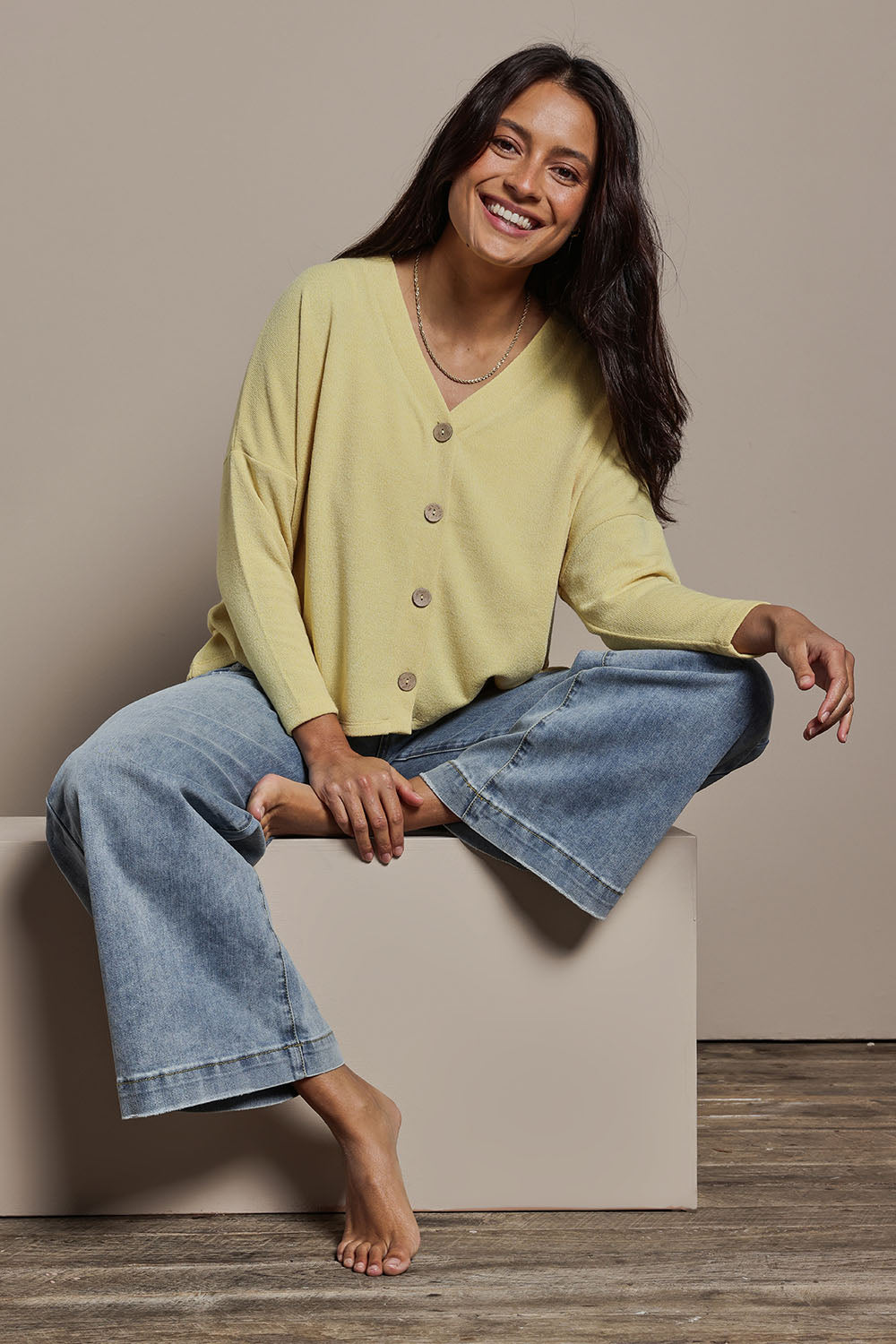 Model Tahnee wearing size 10 of the My Boyfriends Slouch Cardi in colour Butter, from the front, showing the whole outfit