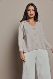 Model Tahnee wearing size 10 of the My Boyfriends Slouch Cardi in colour Sandmarl, from the front, cropped image