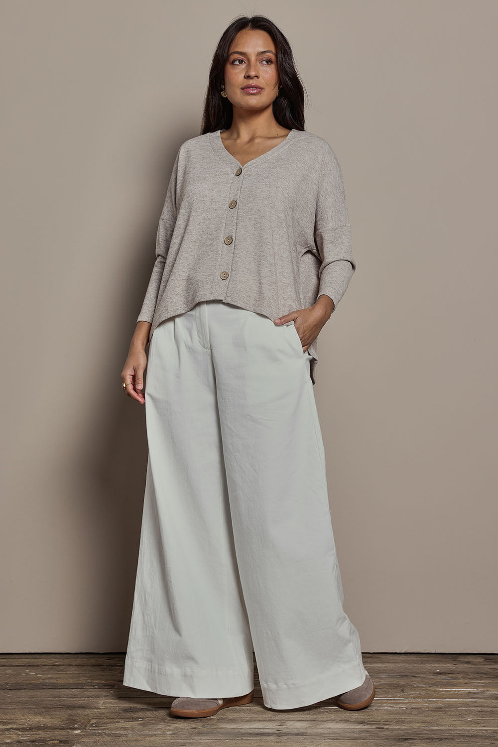 Model Tahnee wearing size 10 of the My Boyfriends Slouch Cardi in colour Sandmarl, from the front, showing the whole outfit