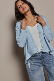 Model Tahnee wearing size 10 of the My Boyfriends Slouch Cardi in colour Skymarl (Blue), from the front, cropped image