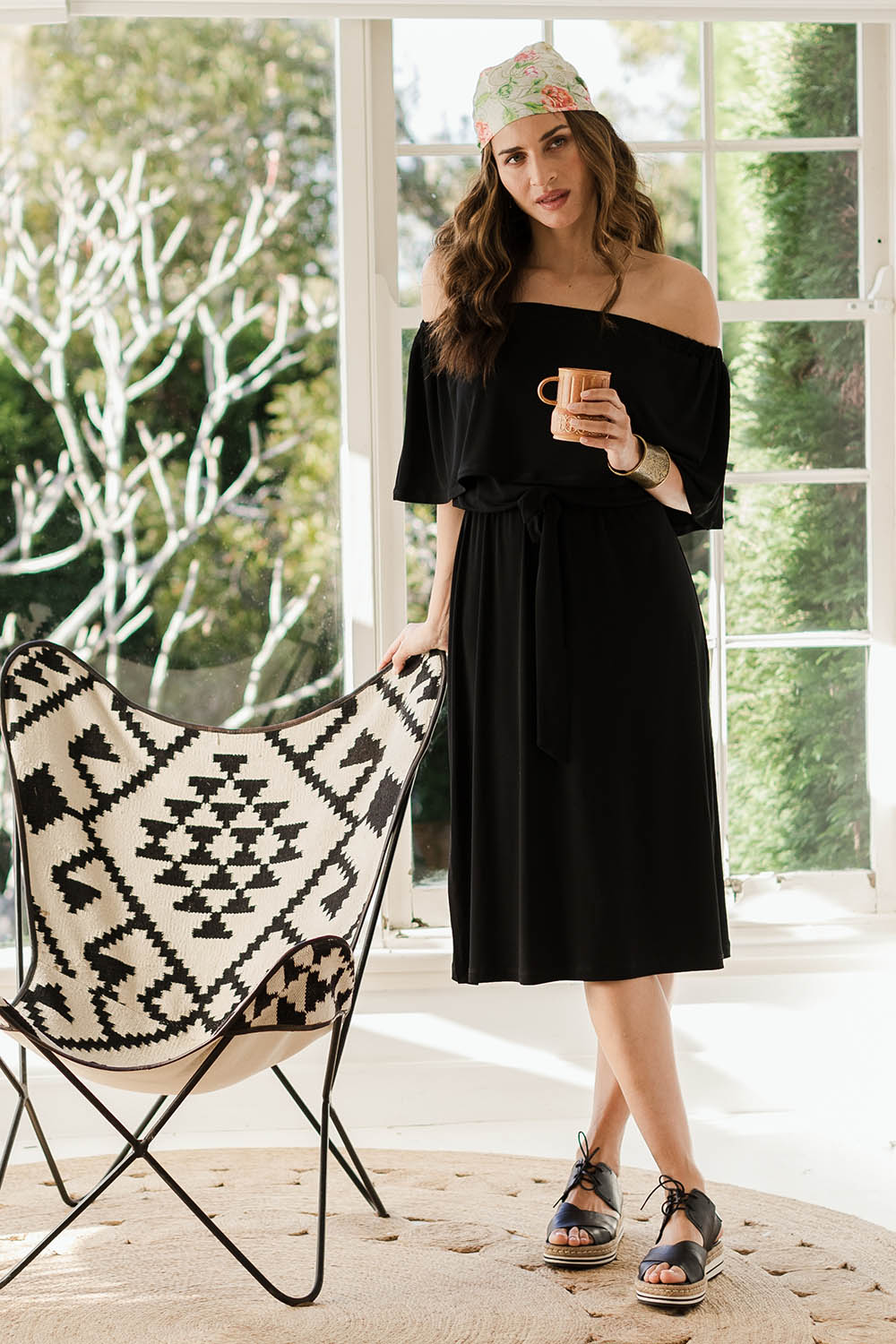 Model Ilona wearing size 10 of The Wanderer In Me Off Shoulder Travel Dress in colour Black (Black), from the front, showing the whole outfit