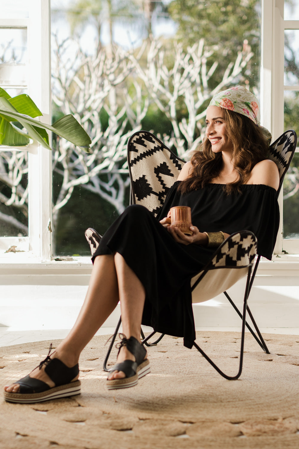 Model Ilona wearing size 10 of The Wanderer In Me Off Shoulder Travel Dress in colour Black (Black), from the front, showing the whole outfit