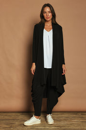 Model Madeline wearing size 10 of The Wanderer In Me Swing Travel Cardi in colour Black (Black), from the front, showing the whole outfit