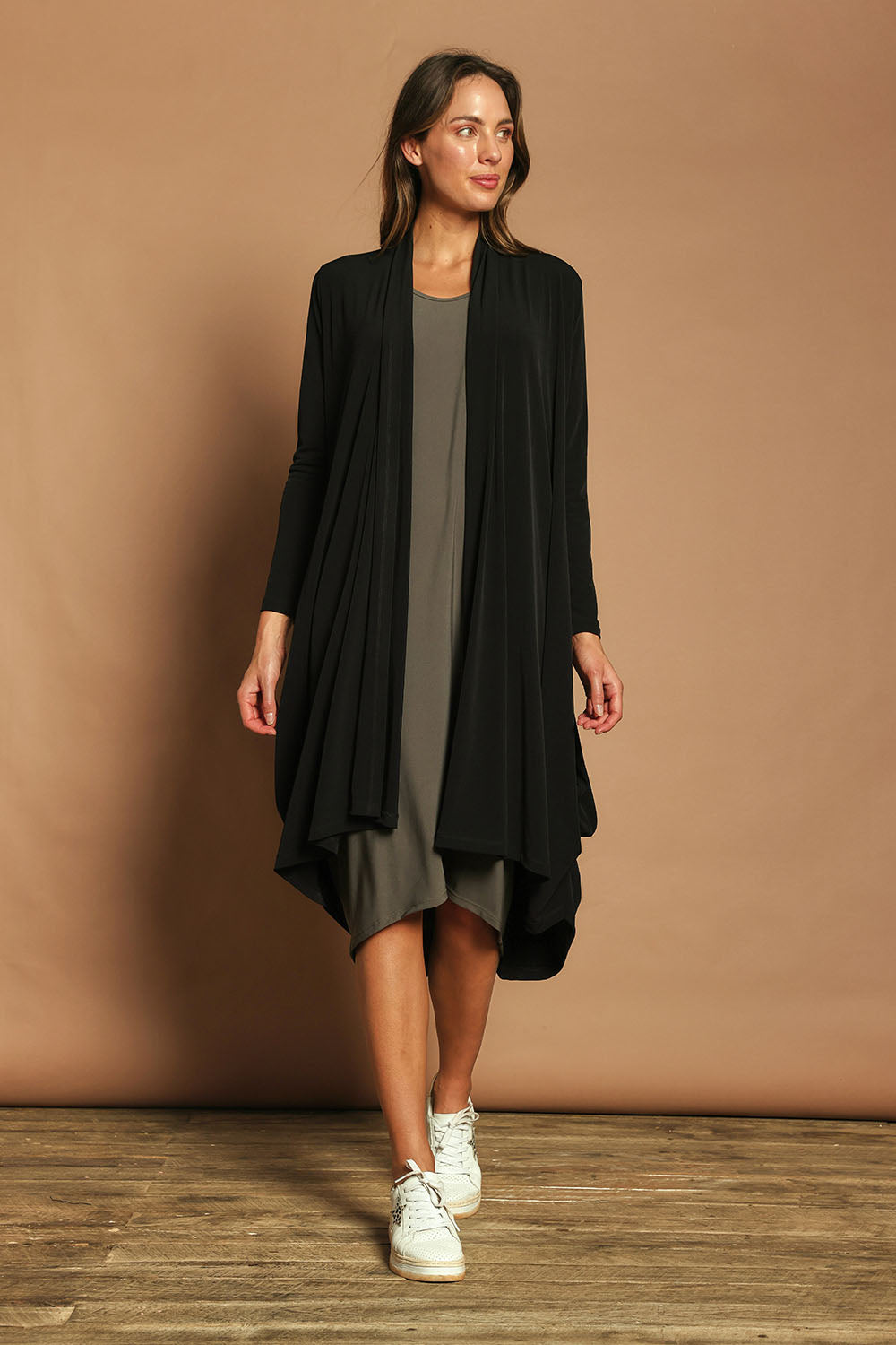 Model Madeline wearing size 10 of The Wanderer In Me Swing Travel Cardi in colour Black (Black), from the front, showing the whole outfit