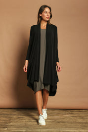 Model Madeline wearing size 10 of The Wanderer In Me Swing Travel Cardi in colour Black (Black), from the front, showing the whole outfit