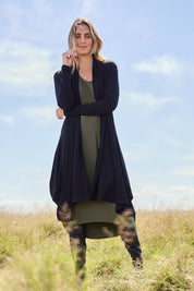 Model Tegan wearing size 10 of The Wanderer In Me Swing Travel Cardi in colour Black (Black), from the front, showing the whole outfit