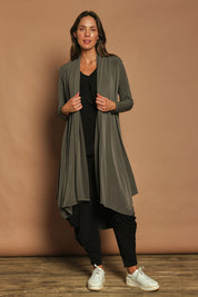 Model Madeline wearing size 10 of The Wanderer In Me Swing Travel Cardi in colour Khaki (Green), from the front, showing the whole outfit
