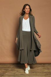 Model Madeline wearing size 10 of The Wanderer In Me Swing Travel Cardi in colour Khaki (Green), from the front, showing the whole outfit