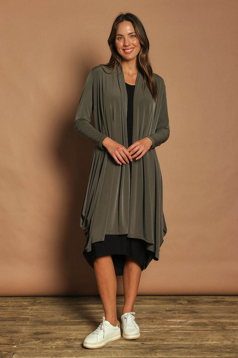 Model Madeline wearing size 10 of The Wanderer In Me Swing Travel Cardi in colour Khaki (Green), from the front, showing the whole outfit