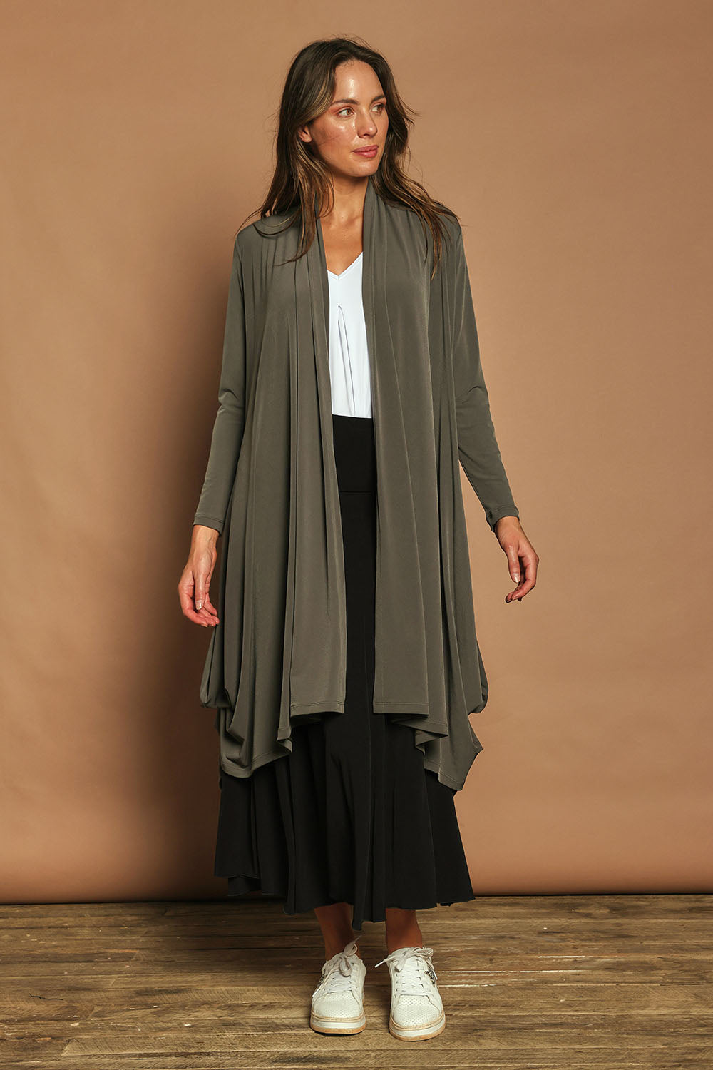 Model Madeline wearing size 10 of The Wanderer In Me Swing Travel Cardi in colour Khaki (Green), from the front, showing the whole outfit