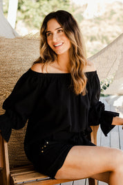 Model Ilona wearing size 10 of the Twinkle In My Eye Off The Shoulder Top in colour Black (Black), from the front, showing the whole outfit