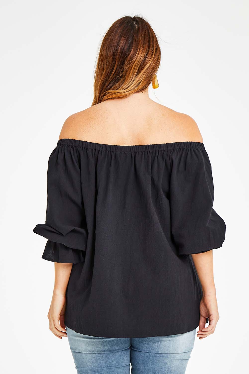 Model Laura wearing size 14 of the Twinkle In My Eye Off The Shoulder Top in colour Black (Black), from the back