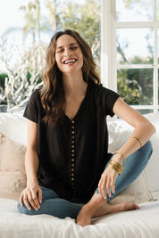 Model Ilona wearing size 10 of the Button Me Up Tunic Tee in colour Black (Black), from the front, showing the whole outfit