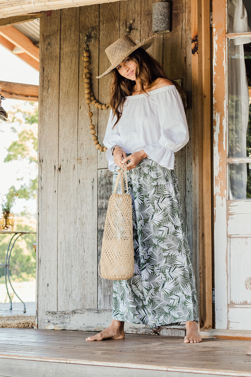 Model Ilona wearing size 10 of the Flowers For Me Pants in colour Leaf (Green), from the front, showing the whole outfit