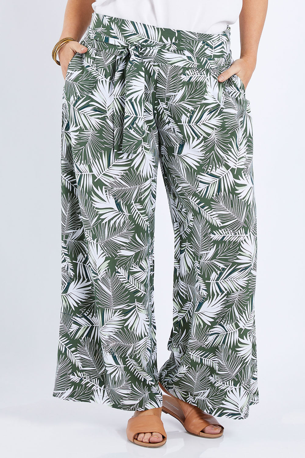 Model Laura wearing size 14 of the Flowers For Me Pants in colour Leaf (Green), from the front, cropped image