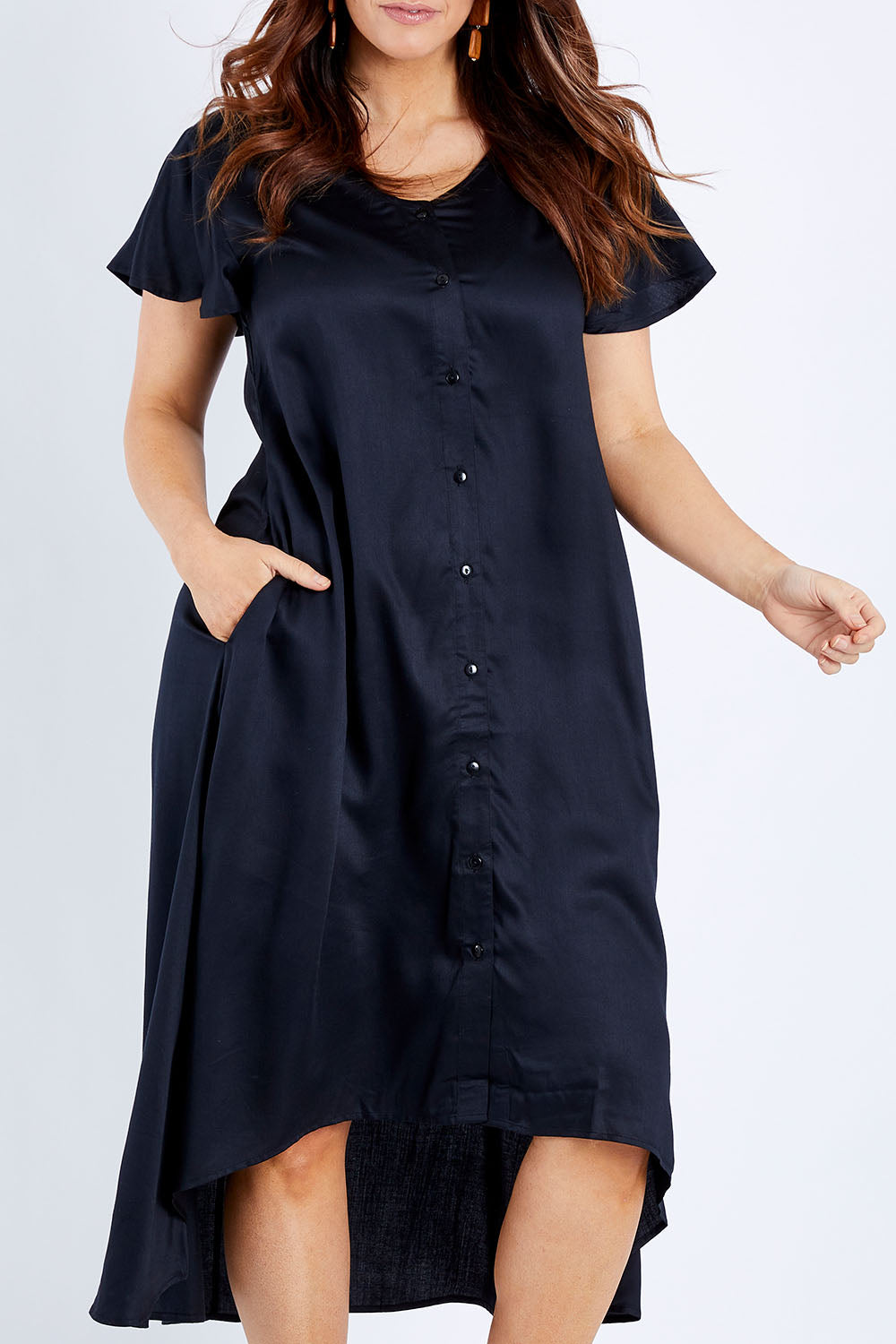 Model Laura wearing size 14 of the Kiss Me Quick Button Dress in colour Black (Black), from the front, cropped image