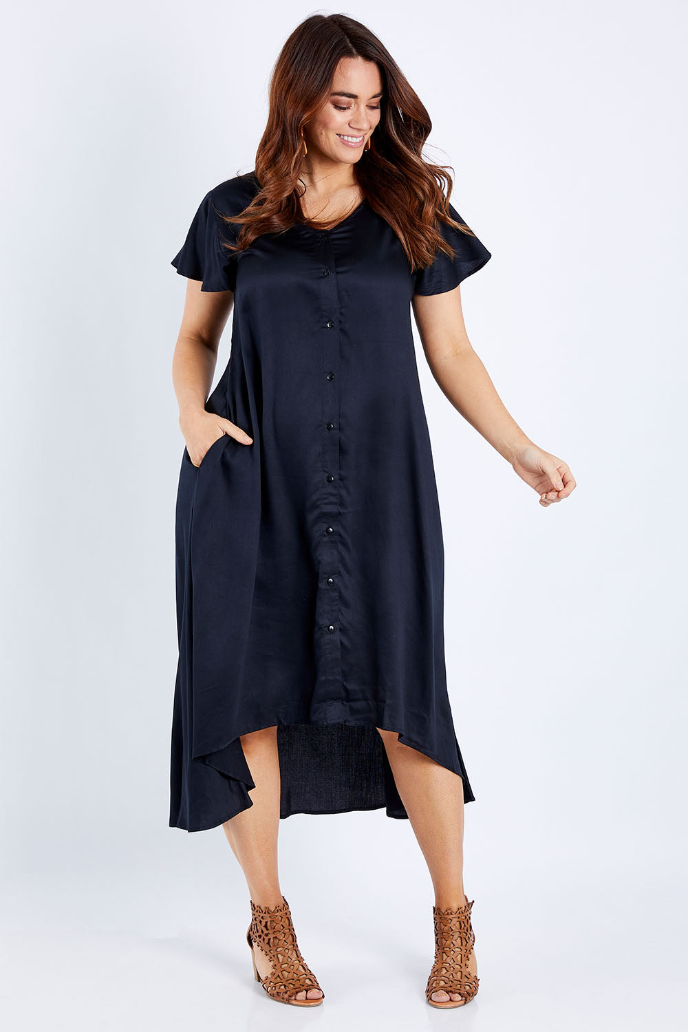 Model Laura wearing size 14 of the Kiss Me Quick Button Dress in colour Black (Black), from the front, showing the whole outfit