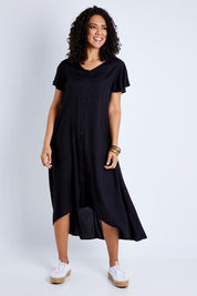 Model Pamela wearing size 10 of the Kiss Me Quick Button Dress in colour Black (Black), from the front, showing the whole outfit