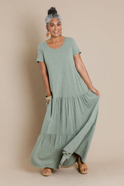 Model Nadine wearing size 10 of the Easy Tiers Maxi Dress in colour Seaspray (Green), from the front, showing the whole outfit