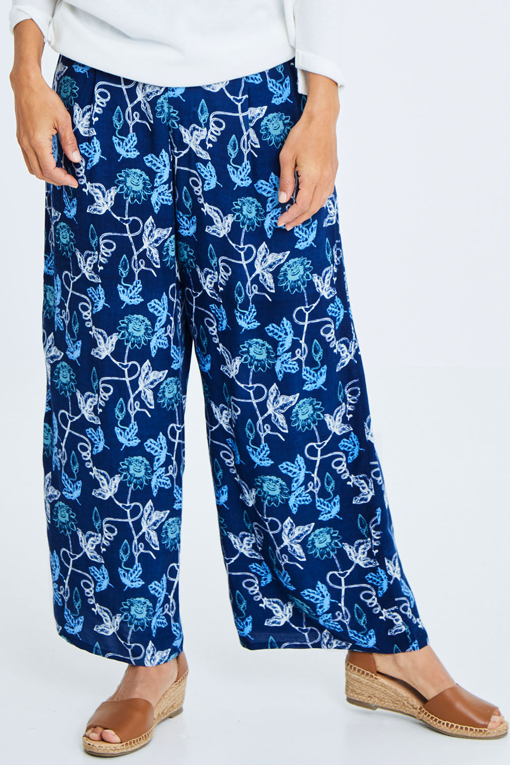 Model Cara wearing size 10 of the My Heart Is Full Flower Pants in colour Deepblue (Blue), from the front, cropped image