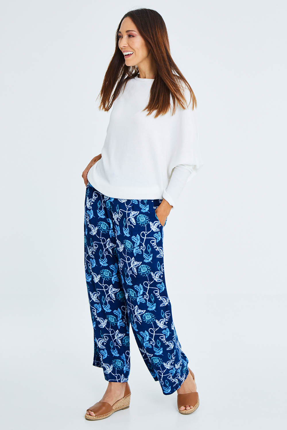 Model Cara wearing size 10 of the My Heart Is Full Flower Pants in colour Deepblue (Blue), from the front, showing the whole outfit