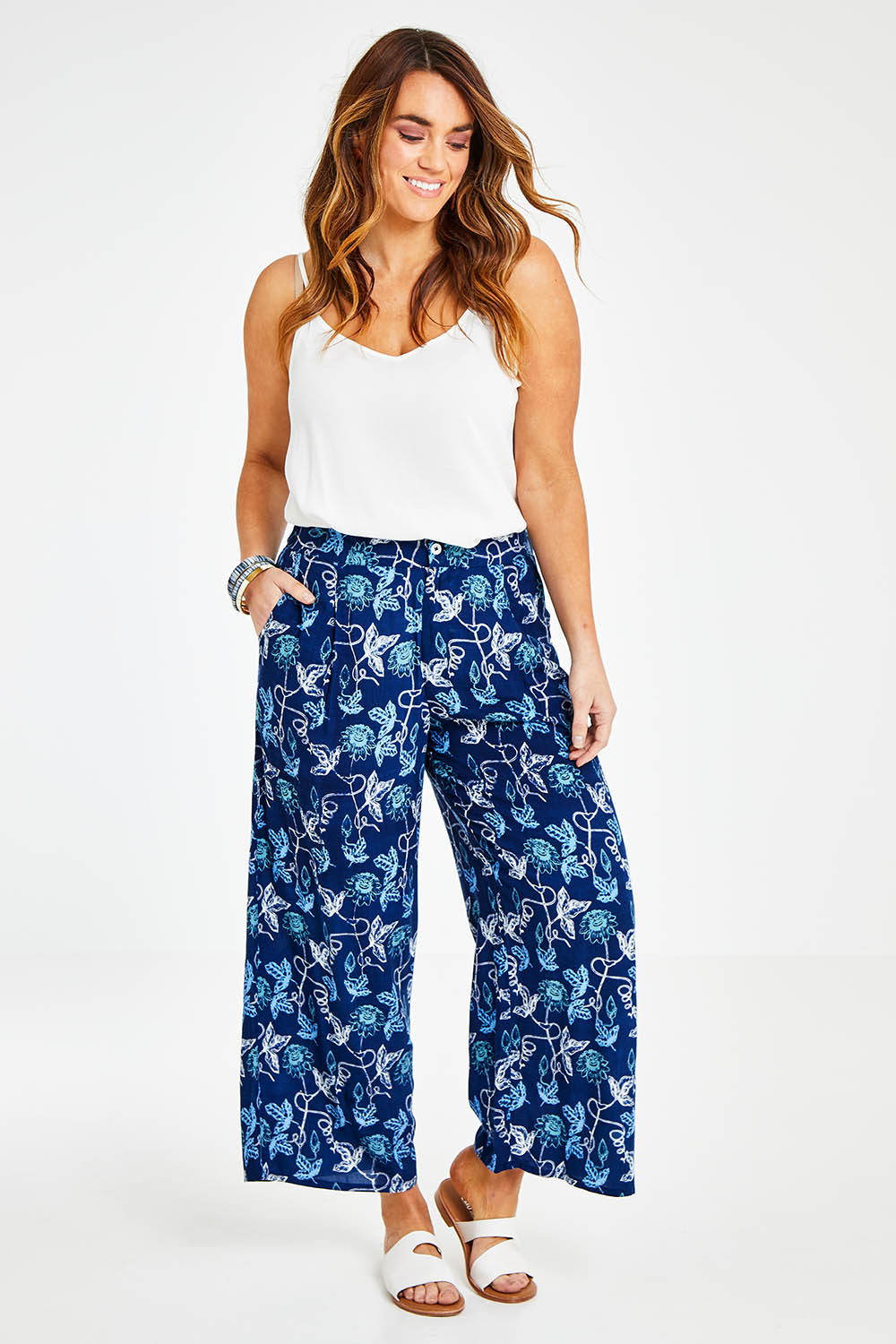 Model Laura wearing size 14 of the My Heart Is Full Flower Pants in colour Deepblue (Blue), from the front, showing the whole outfit
