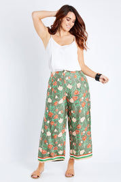 Model Laura wearing size 14 of the My Heart Is Full Flower Pants in colour Khaki (Green), from the front, showing the whole outfit