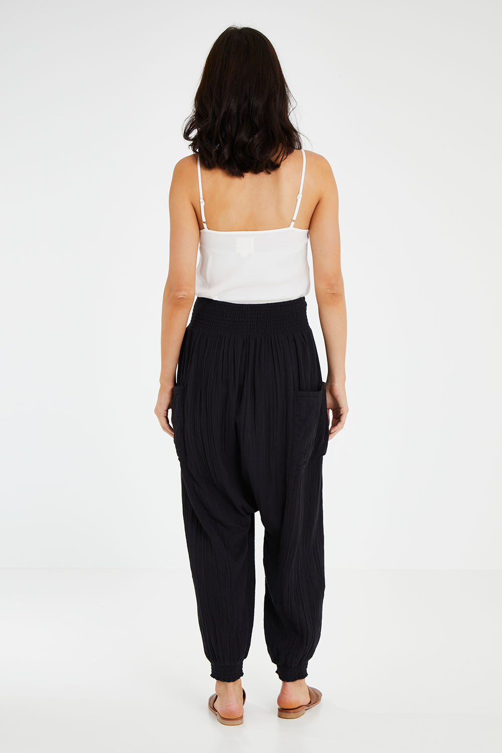 Model Andrea wearing size 10 of the Beach Breeze Cotton Slouch Pants in colour Black (Black), from the back