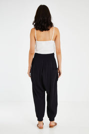 Model Andrea wearing size 10 of the Beach Breeze Cotton Slouch Pants in colour Black (Black), from the back