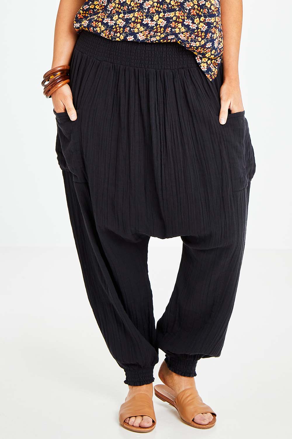 Model Laura wearing size 14 of the Beach Breeze Cotton Slouch Pants in colour Black (Black), from the front, cropped image