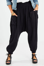 Model Sasha-Lee wearing size 16 of the Beach Breeze Cotton Slouch Pants in colour Black (Black), from the front, cropped image