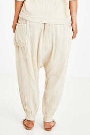 Model Laura wearing size 14 of the Beach Breeze Cotton Slouch Pants in colour Wheat, from the back