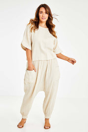 Model Laura wearing size 14 of the Beach Breeze Cotton Slouch Pants in colour Wheat, from the front, showing the whole outfit