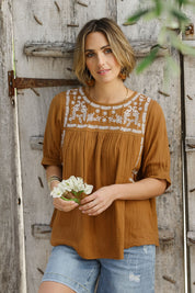 Model Tegan wearing size 10 of the Secret Garden Cotton Blouse in colour Clay, from the front, showing the whole outfit