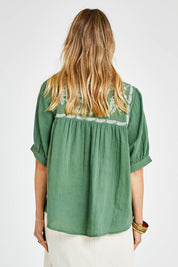 Model Kelly wearing size 10 of the Secret Garden Cotton Blouse in colour Olive (Green), from the back