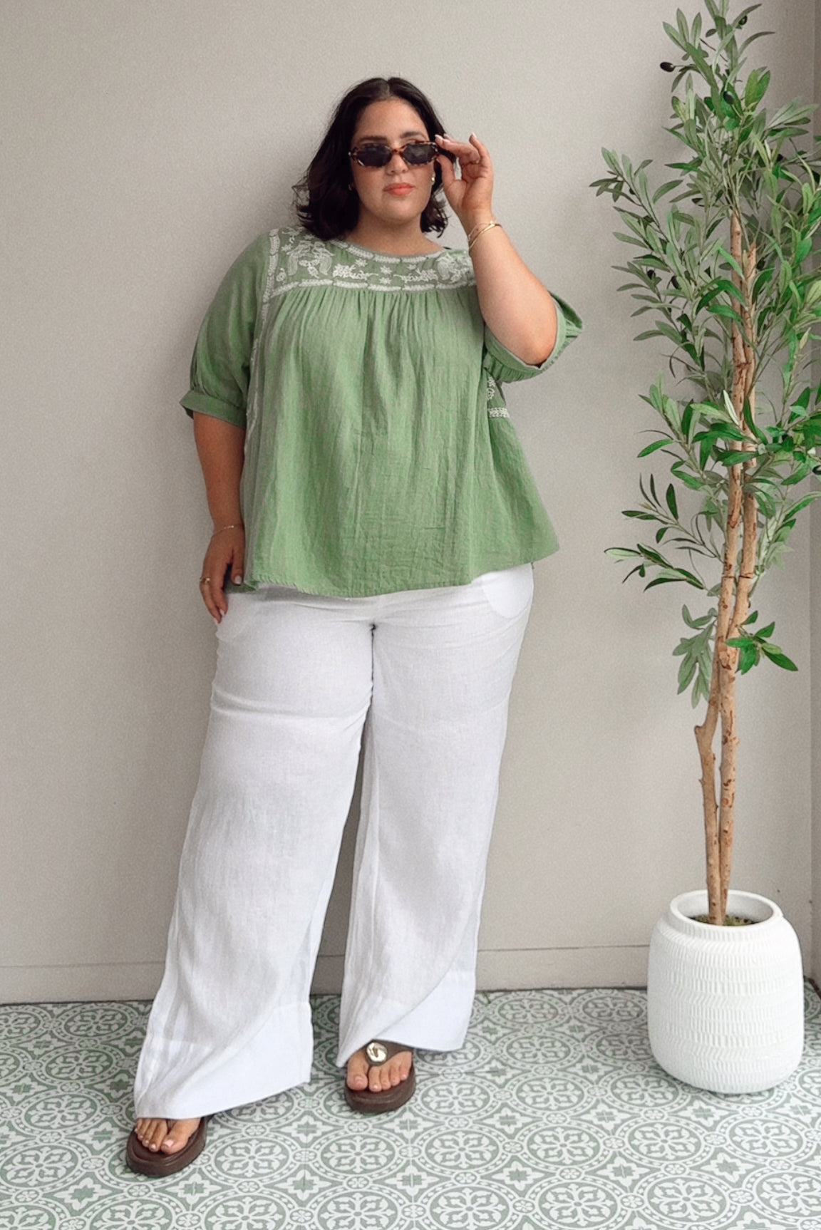 Model Maddy wearing size 22 of the Secret Garden Cotton Blouse in colour Olive (Green), from the front, showing the whole outfit