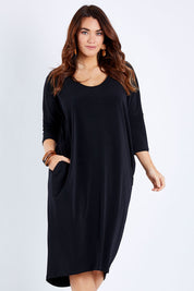 Model Laura wearing size 14 of The Wanderer In Me Travel Dress in colour Black (Black), from the front, cropped image