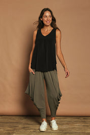 Model Madeline wearing size 10 of The Wanderer In Me V Neck Travel Singlet in colour Black (Black), from the front, showing the whole outfit