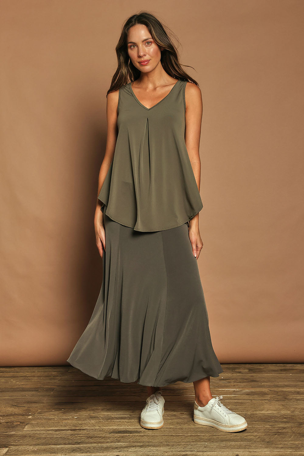 Model Madeline wearing size 10 of The Wanderer In Me V Neck Travel Singlet in colour Khaki (Green), from the front, showing the whole outfit