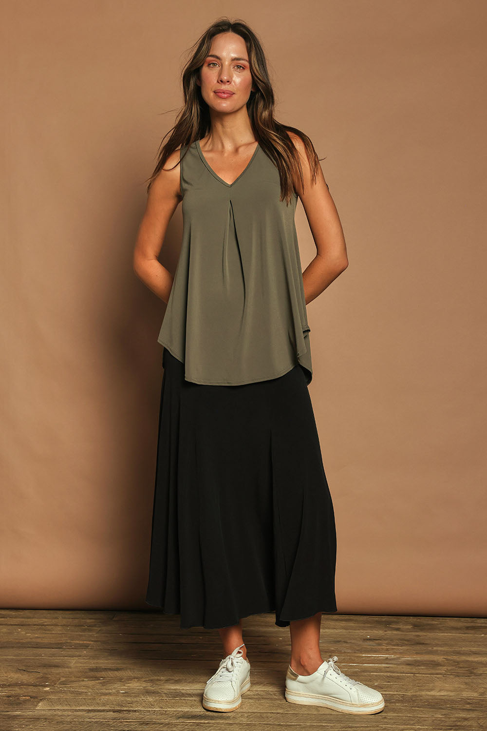 Model Madeline wearing size 10 of The Wanderer In Me V Neck Travel Singlet in colour Khaki (Green), from the front, showing the whole outfit