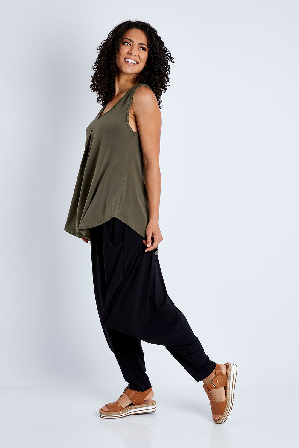 Model Pamela wearing size 10 of The Wanderer In Me V Neck Travel Singlet in colour Khaki (Green), from the front, showing the whole outfit