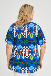 Model Keeara wearing size 16 of the Free Falling Top in colour Royal (Blue), from the back