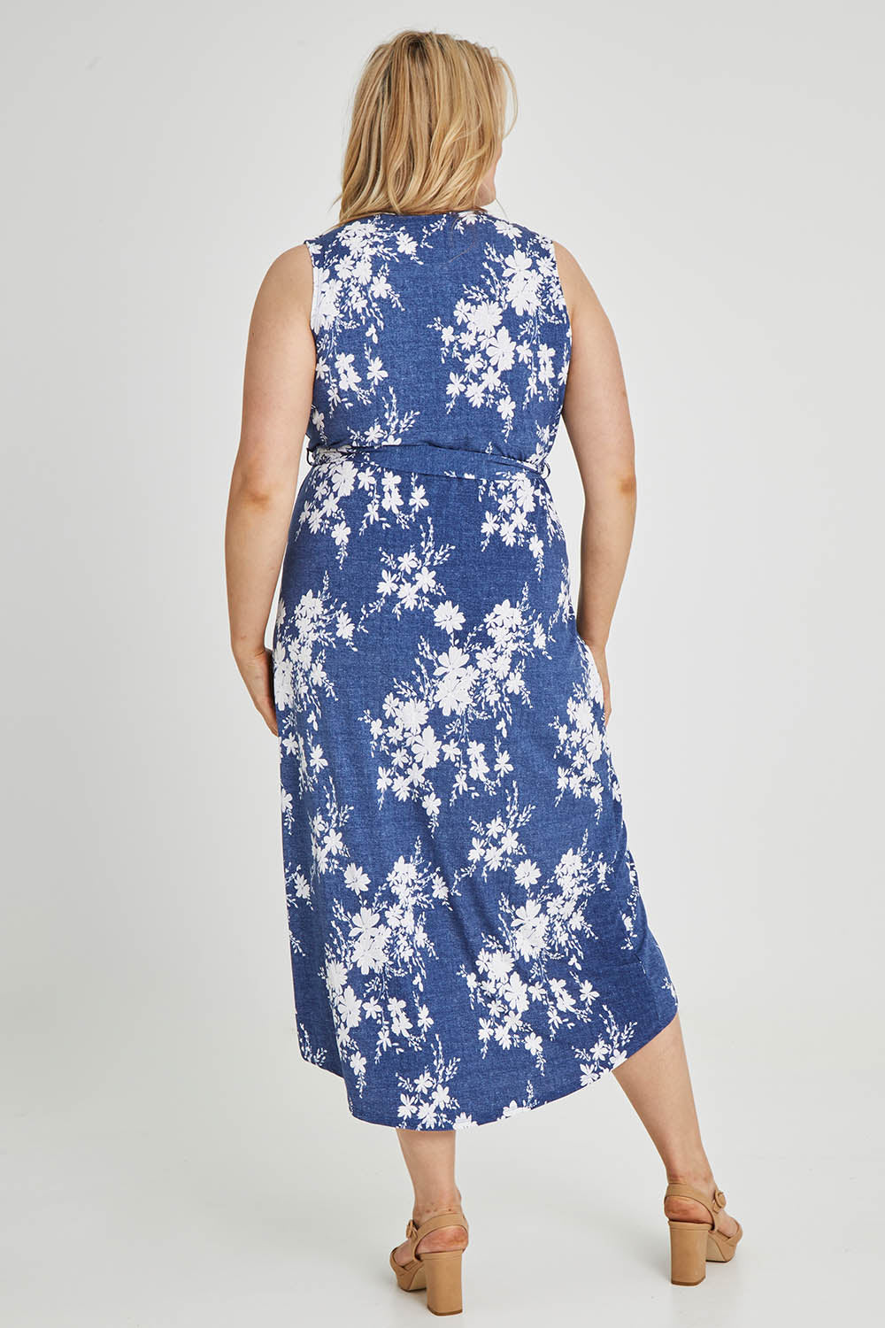 Model Keeara wearing size 16 of the Freedom Faux Wrap Dress in colour Denim (Blue), from the back