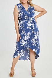 Model Keeara wearing size 16 of the Freedom Faux Wrap Dress in colour Denim (Blue), from the front, cropped image